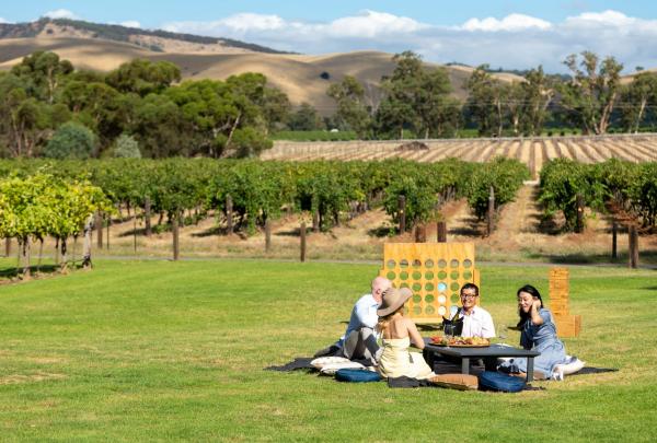People dining outdoors at Jacob's Creek, Rowland Flat, Barossa Valley, South Australia © Tourism Australia