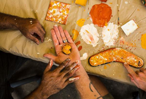 Learning about Aboriginal culture through boomerang painting at Janbal Gallery, Down Under Tours - Daintree Dreaming, Mossman Gorge, Queensland © Tourism and Events Queensland
