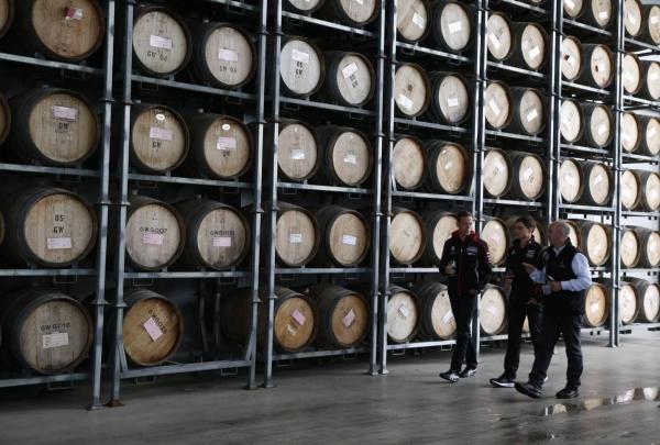 Men viewing the barrel storage on a tour at Josef Chromy Wines, Relbia, Tamar Valley, Tasmania © Tourism Australia