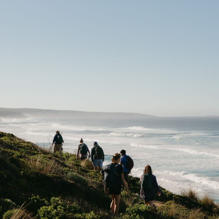 Group of hikers walking across the coastline of Flinders Chase National Park, Kangaroo Island, South Australia © Tourism Australia