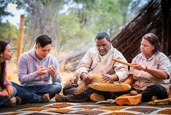 Two people learning about Aboriginal culture from guides from Karrke Aboriginal Cultural Experience & Tours, Red Centre, Northern Territory © Tourism Australia