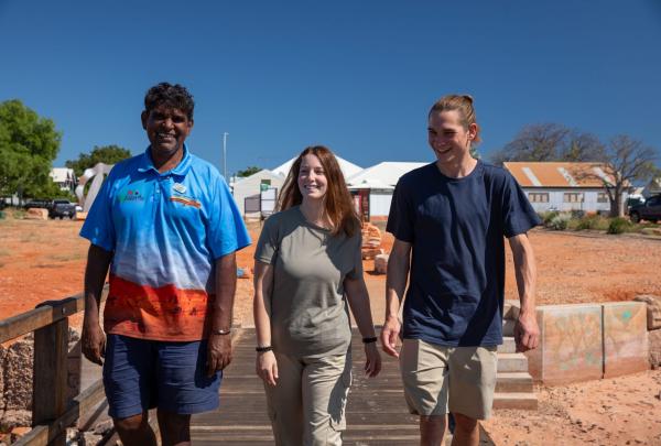 Guide (Robert Dann) with visitors Rebecca Iranzo Bennett and Joshua Aylmore talk on the old pier in Broome Western Australia © Tourism Australia