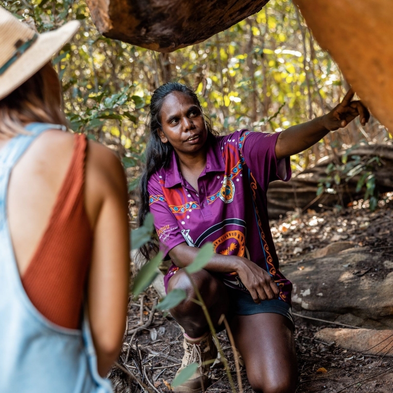 Tour Guide showing a woman an item on the tour, Kingfisher Tours, Kimberley, Western Australia © Tourism Australia