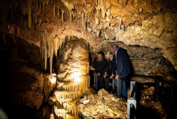 Two people and a guide exploring a cave on a Koomal Dreaming tour, Yallingup, South West Western Australia © Tourism Australia