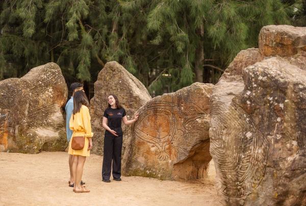 The image captures a group of engaged participants on the Birrarung Wilam Walk Tour, Koorie Heritage Trust, Melbourne, Victoria © Tourism Australia