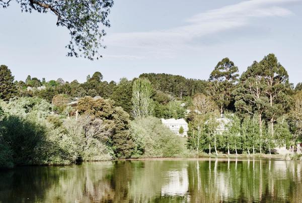 An exterior shot of The Lake House taken at a distance over the lake, Daylesford, Victoria © Lake House