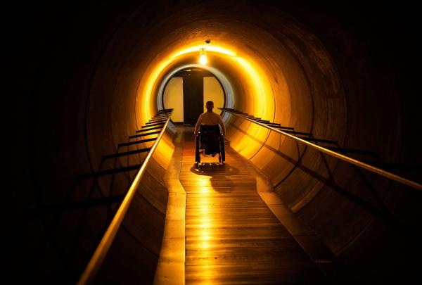 A guest in an exhibition tunnel at MONA, Hobart, Tasmania © MONA