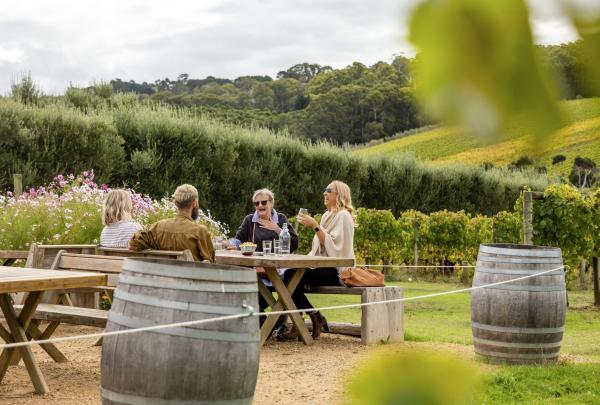Group dining outside in the garden at Montalto, Red Hill South, Mornington Peninsula, Victoria © Tourism Australia