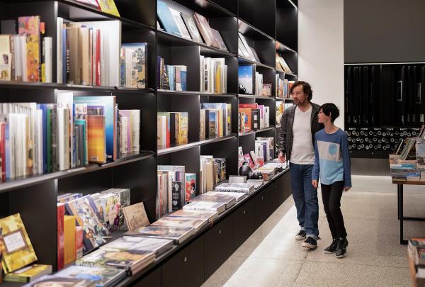 A father and son admire the books on display in the bookshop of the National Gallery of Australia, Canberra, Australian Capital Territory © Tourism Australia