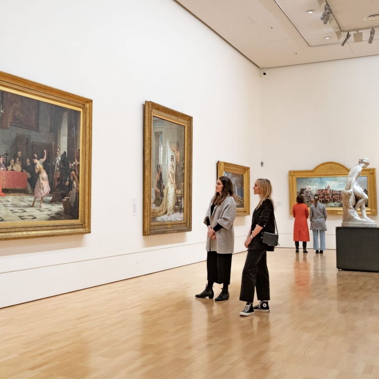 Two women admire artworks at the National Gallery of Victoria, Melbourne, Victoria © Tourism Australia