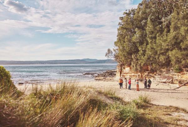 Dwayne Bannon Harrison sharing Aboriginal cultural stories in yarning circle with guests as part of Yuin Retreat, Ngaran Ngaran Culture Awareness, Eurobodalla National Park, New South Wales © Tourism Australia