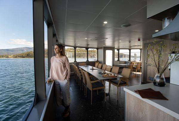 On Board's expedition vessel Odalisque III features a dining room encircled by vast windows, Southwest National Park, Tasmania © Tourism Australia
