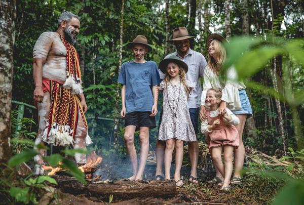 Guide doing a smoking ceremony with a family as part of the Pamagirri Aboriginal Experience, Tropical North Queensland, Queensland © Tourism Australia
