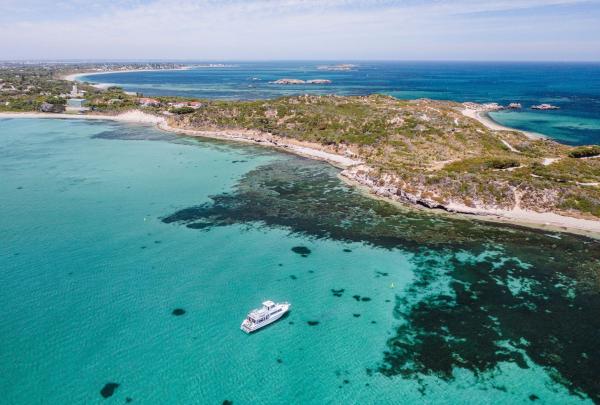 Aerial view of a boat on the vibrant blue waters of Rockingham, Perth Western Australia © Tourism Australia