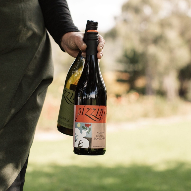 Person with wine bottles in hand at Pizzini Wines, Whitfield, King Valley, Victoria © Tourism Australia