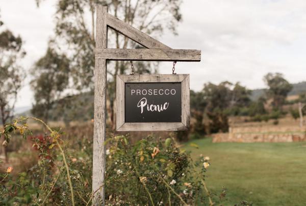 SIgn in the garden saying 'Prosecco picnic' at Pizzini Wines, Whitfield, King Valley, Victoria © Tourism Australia