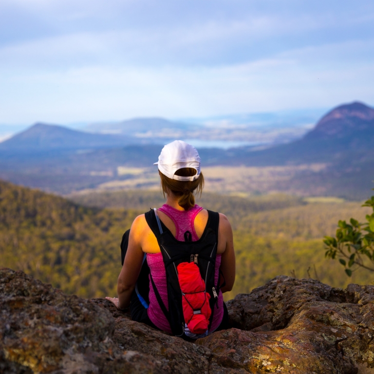 Woman looking out at view of mountains, Scenic Rim Trail, Governors Chair Lookout, Main Range National Park, Queensland © Spicers Retreat/ Great Walks of Australia