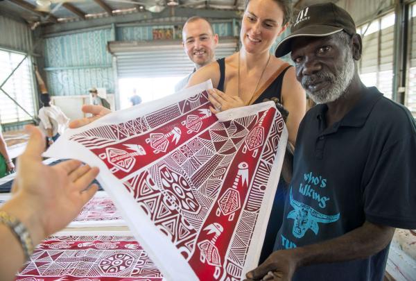 Group looking at artwork, Sealink NT - Tiwi Islands, Wurrumiyanga, Bathurst Island, Northern Territory © SeaLink NT