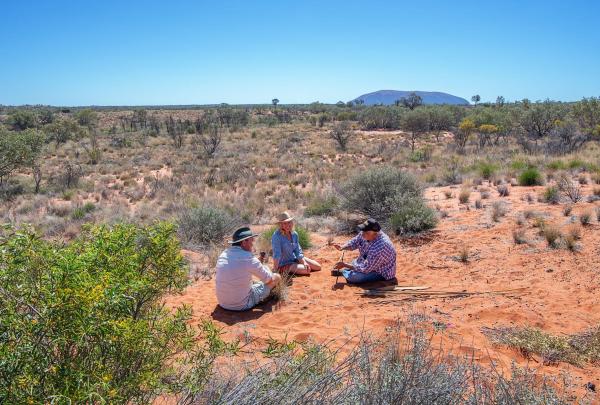 Couple and Aboriginal guide from SEIT Outback Australia at Uluru-Kata Tjuta National Park, Yulara, Northern Territory © Tourism Australia