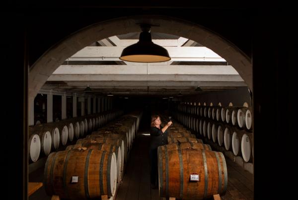 Woman in the wine cellar at Seppeltsfied, Seppeltsfield, Barossa Valley, South Australia © Tourism Australia