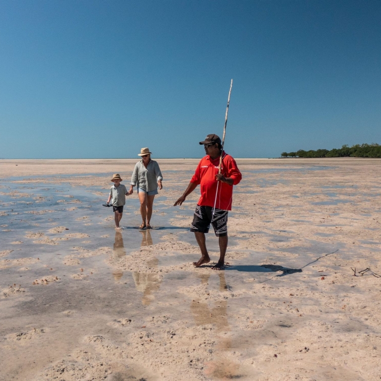Mother and son with an Indigenous guide spearfishing on the tidal flats in Dampier Peninsula, Western Australia © James Fisher Photography/Tourism Australia