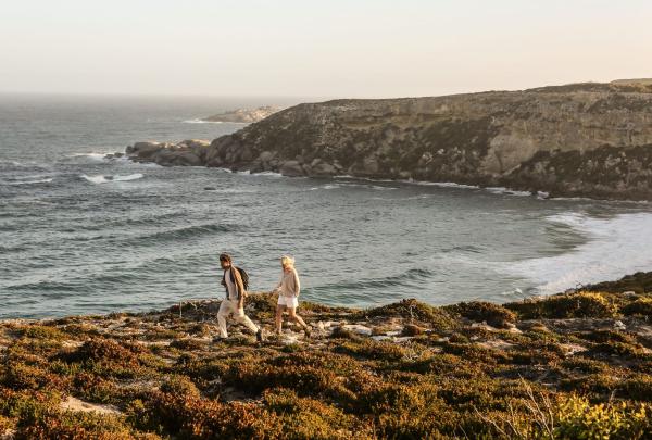 Two people walk on clifftop at Southern Ocean Lodge in Kangaroo Island, South Australia © Tourism Australia