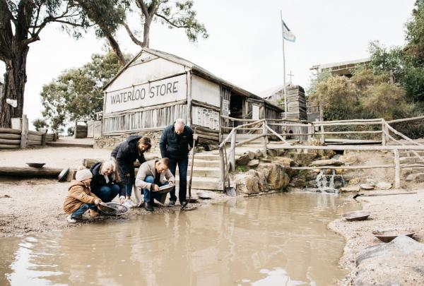 Family panning for gold at Sovereign Hill, Ballarat, Victoria © Tourism Australia