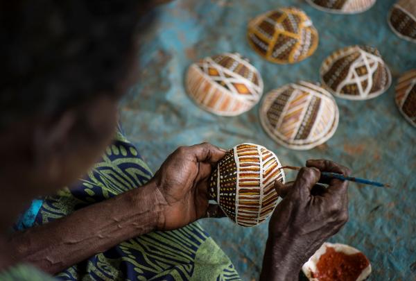 An Aboriginal artist painting at Tiwi Design, Tiwi Tours, Wurrumiyanga, Bathurst Island, Northern Territory © Tourism NT