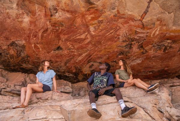 Guide showing a tour rock art, Venture North Safaris, Arnhem Land, Northern Territory © Tourism Australia