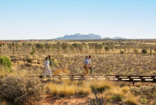 People walking along a boardwalk, Voyages Indigenous Tourism Australia, Uluru-Kata Tjuta National Park, Northern Territory © Tourism Australia
