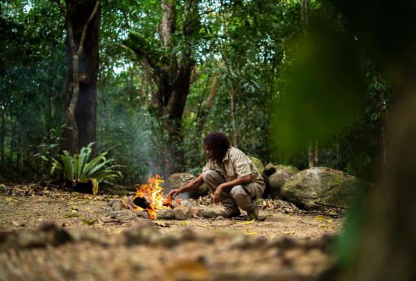 Guide over a fire on the Dreamtime Gorge Walk, Mossman Gorge, Far North Queensland, Queensland © Tourism and Events Queensland