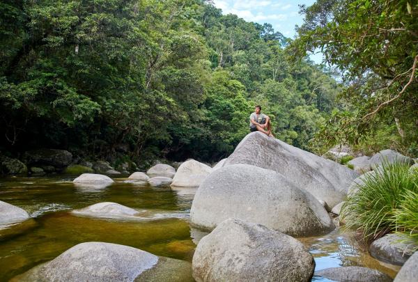 Owner / operator Juan Walker sitting on a rock at Mossman Gorge, Tropical North Queensland, Queensland © Walkabout Cultural Adventures