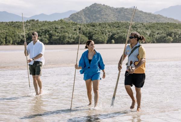 Two individuals and their guide are strolling along Cooya Beach in Mossman, Tropical North Queensland, Queensland © Tourism Australia