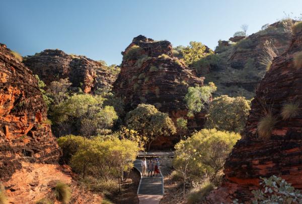 Visitors walk with their guide (Cathy Ward) on the hiking trail in Mirima National Park, Waringarri Aboriginal Arts & Tours, East Kimberley, Western Australia © Tourism Australia