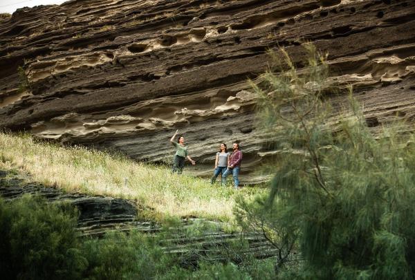 Group exploring rock formation at Worn Gundidj @ Tower Hill, Great Ocean Road, Victoria © Tourism Australia