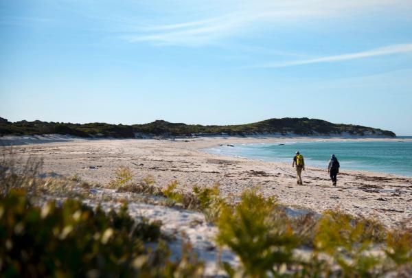 Two people walking along the beach on the wukalina Walk, Bay of Fires, Tasmania © The wukalina Walk